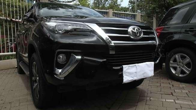 Mobil Toyota Fortuner berwarna hitam dengan nomor polisi B 15 DIL yang diamankan penyidik KPK dalam Operasi Tangkap Tangan (OTT) melibatkan pejabat Bakamla di Jakarta, tampak terparkir, Kamis (15/12/2016). [Suara.com/Oke Atmaja]