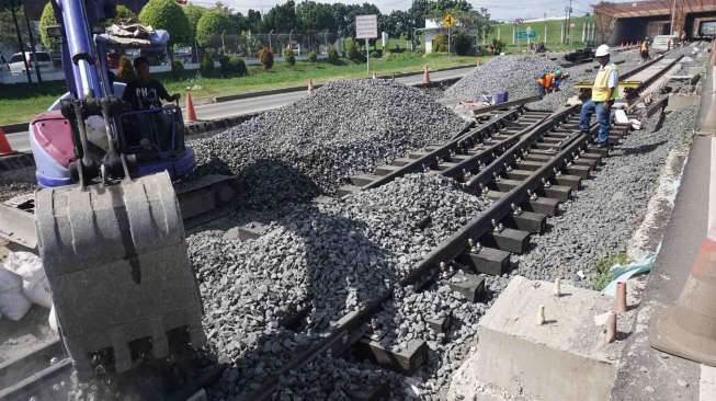 Pekerja PT Kereta Api Indonesia (KAI) menyelesaikan pembangunan rel kereta api bandara Soekarno-Hatta, di Tangerang, Banten, Kamis (19/1).