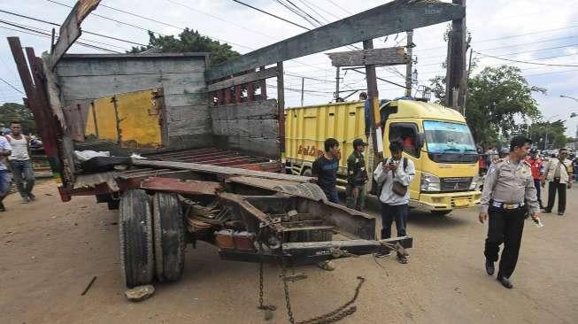 Petugas mengevakuasi sebuah truk bak terbuka yang tertabrak kereta api Cirebon Express di perlintasan depan LP Cipinang, Jakarta, Rabu (25/1).