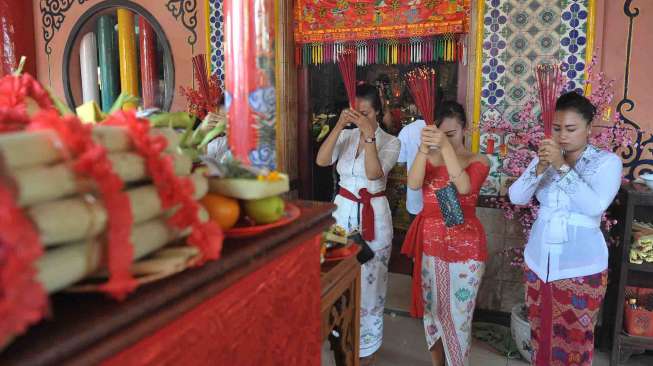 Sejumlah umat menggelar ritual tolak bala Imlek 2568 di Jalan Raya Kawasan Kuta, Bali, Jumat (27/1).