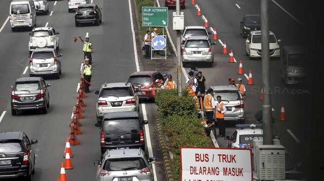 Sejumlah kendaraan roda empat melintas di ruas jalan Tol Dalam Kota ketika diberlakukan uji coba 