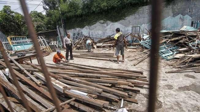 Petugas PPSU membersihkan sisa puing reruntuhan bangunan sekolah di Jalan H Samali, Gang Ayub, Pejaten Barat, Pasar Minggu, Jakarta, Rabu (22/2)