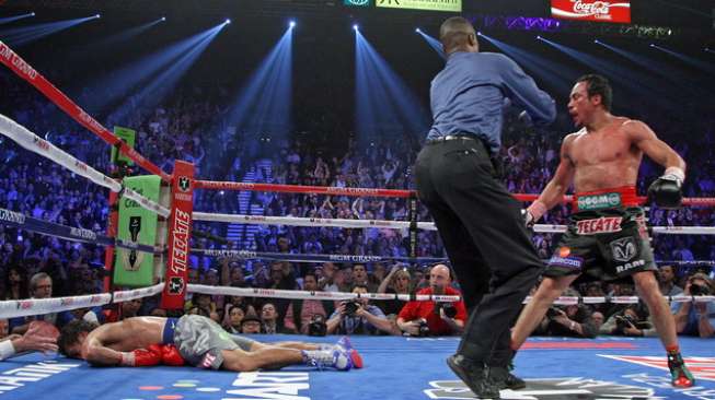 Manny Pacquiao tersungkur di kanvas usai mendapat pukulan telak dari Juan Manuel Marquez (kanan) dalam duel Jilid IV kedua petinju di MGM Grand Arena, AS, 8 Desember 2012 [AFP]