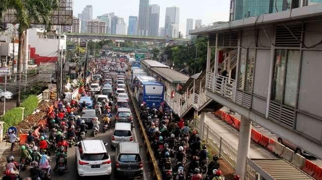 Sejumlah kendaraan bermotor antre dalam kemacetan di samping proyek underpass di Jalan Mampang, Jakarta Selatan, Rabu (12/4). 