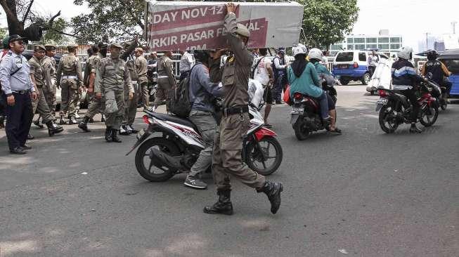 Petugas gabungan Dinas Perhubungan dan Satpol PP Provinsi DKI Jakarta melakukan penertiban parkir liar dan pedagang kaki lima di kawasan Tanah Abang, Jakarta, Kamis (4/5).