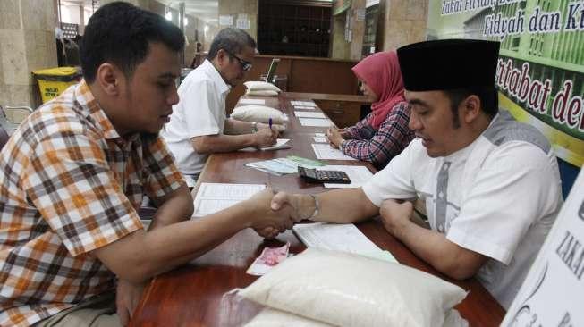 Warga melakukan akad pembayaran zakat fitrah melalui lembaga amil zakat di Masjid Istiqlal, Jakarta, Kamis (22/6/2017). [Suara.com/Oke Atmaja]