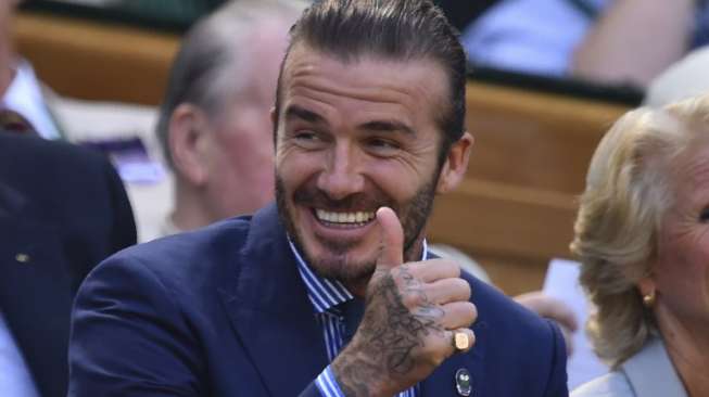 Mantan pemain Manchester United dan Real Madrid David Beckham menyaksikan tenis Wimbledon. Glyn KIRK / AFP