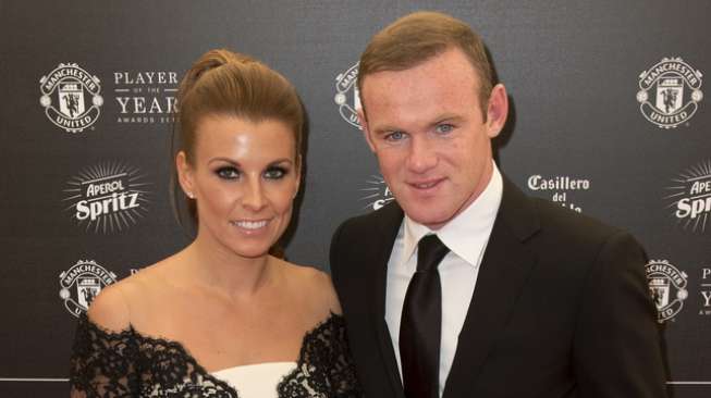 Wayne Rooney dan istrinya Coleen. [AFP/Oli Scarff]