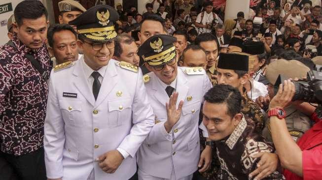 Gubernur dan Wakil Gubernur DKI Jakarta terbaru, Anies Baswedan-Sandiaga Uno, mengikuti prosesi Serah Terima Jabatan (Sertijab) di Balai Kota DKI, Senin (16/10/2017), usai sebelumnya resmi dilantik oleh Presiden Joko Widodo. [Suara.com/Kurniawan Mas'ud]