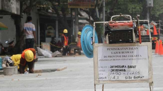 Pekerja menyelesaikan peningkatan lajur transjakarta di Jatinegara, Jakarta, Sabtu (21/10).