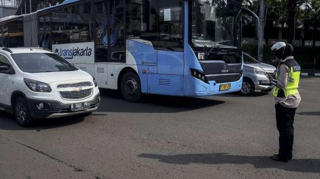 Polisi Lalu lintas memberhentikan kendaraan yang melintas untuk mengheningkan cipta sejenak di kawasan Bundaran HoteI Indonesia, Jakarta, Jumat (10/11).