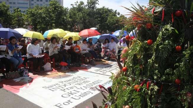 Jemaat GKI Yasmin Bogor dan HKBP Filadelfia Bekasi mengikuti ibadah perayaan Natal di seberang Istana Merdeka, Jakarta, Senin (25/12).