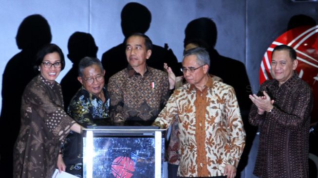 Presiden Joko Widodo didampingi Menteri Koordinator Perekonomian Darmin Nasution, Menteri Keuangan Sri Mulyani, Ketua Dewan Komisioner Otoritas Jasa Keuangan (DK OJK) Wimboh Santoso, Gubernur Bank Indonesia Agus Martowardojo dan Dirut BEI Tito Sulistio menghadiri penutupan perdagangan saham di Gedung Bursa Efek Indonesia, Jakarta, Jumat (29/12).