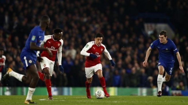 Pemain Arsenal Alexis Sanchez menggiring bola saat berhadapan dengan Chelsea di ajang Piala Liga [AFP]