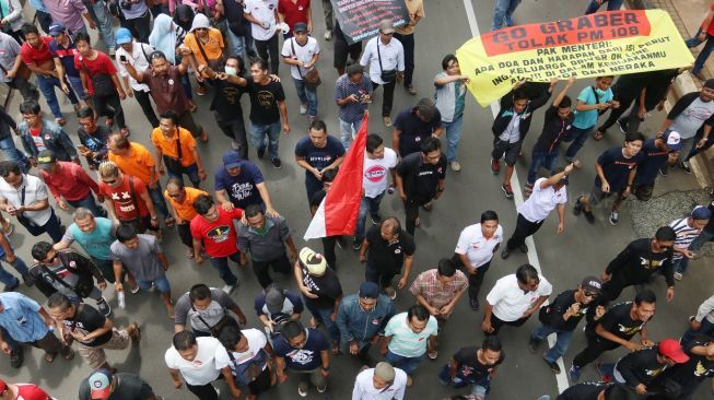 Driver taksi online melakukan aksi unjuk rasa di kawasan Monas, Jakarta, Senin (29/1).