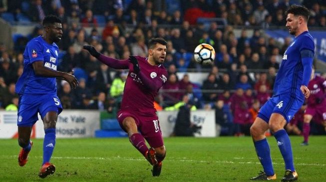 Sergio Aguero melepaskan tembakan di tengah kawalan dua pemain Cardiff City [AFP]