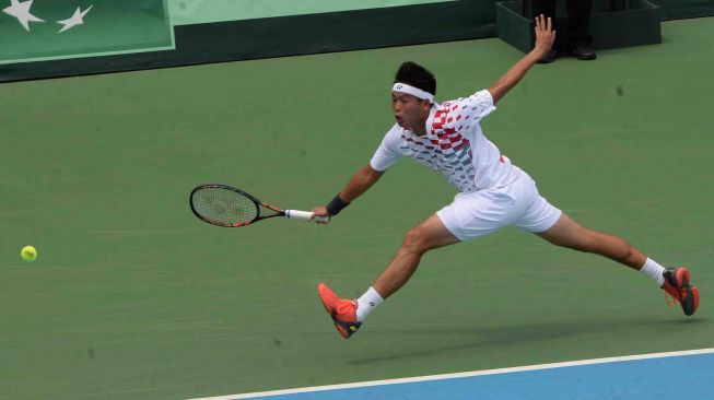 Petenis Indonesia David Agung Susanto melawan petenis Filipina Jeson Patrombon dalam partai kedua Piala Davis Grup II Zona Asia/Oseania di Stadion Tenis GBK, Jakarta, Sabtu (3/2).