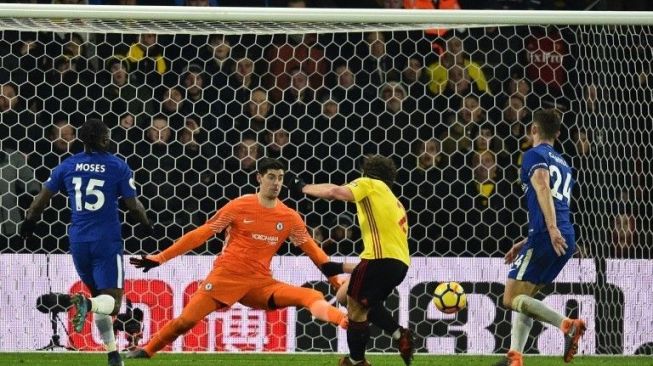 Bek Watford Daryl Janmaat (tengah) menaklukkan kiper Chelsea Thibaut Courtois. Glyn KIRK / AFP