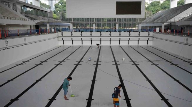 Sejumlah pekerja melakukan perawatan Stadion Akuatik di Kompleks Gelora Bung Karno (GBK), Senayan, Jakarta, Kamis (22/3). 