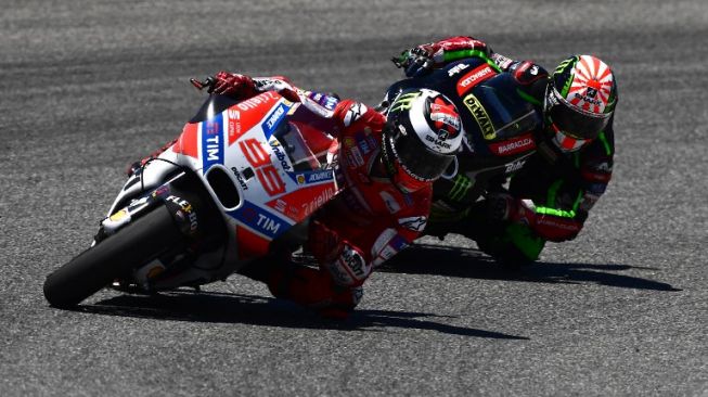 Pebalap Monster Yamaha Tech 3, Johann Zarco menguntit rider Ducati, Jorge Lorenzo. [AFP/Pierre-Philippe Marcou]