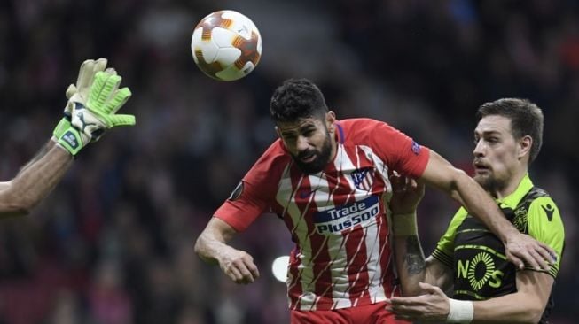 Striker Atletico Madrid Diego Costa (kiri) menyundul bola saat menghadapi Sporting Lisbon. GABRIEL BOUYS / AFP