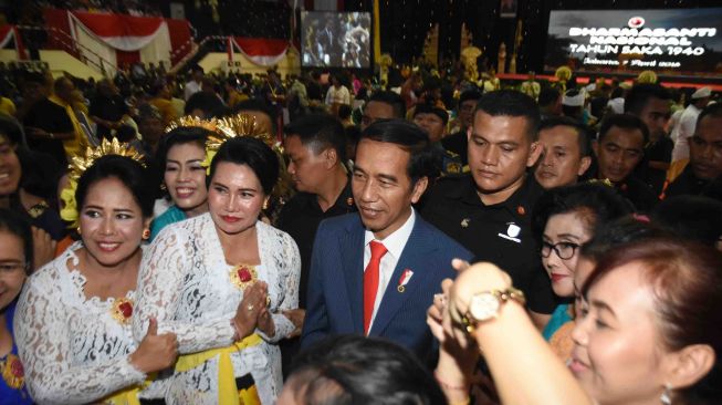 Presiden Joko Widodo berfoto bersama umat Hindu usai menghadiri acara Dharma Santi Nasional Perayaan Hari Raya Nyepi Tahun Baru Saka 1940 di GOR Ahmad Yani, Mabes TNI Cilangkap, Jakarta Timur, Sabtu (7/4).