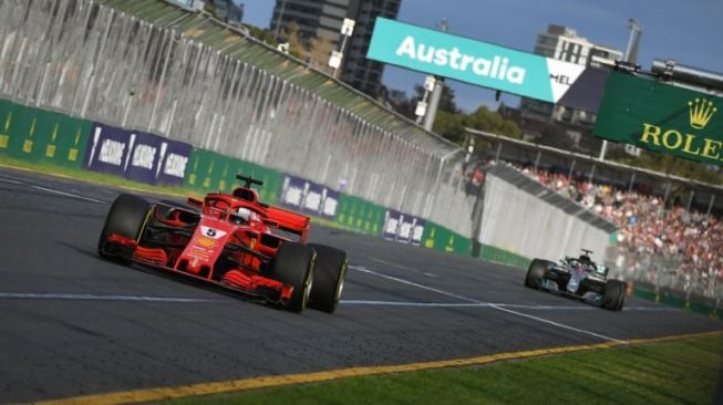 Pebalap Ferrari, Sebastian Vettel memimpin balapan GP Australia di depan driver Mercedes, Lewis Hamilton. [AFP/William West]