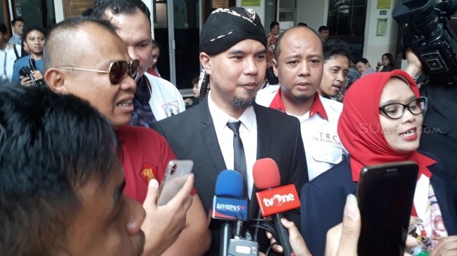 Ahmad Dhani mengenakan setelan jas dan belangkon dalam sidang ujaran kebencian di PN Jakarta Selatan, Senin (23/4/2018). (Wahyu Tri Laksono/Suara.com)