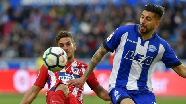 Pemain Atletico Madrid Koke (kiri) berebut bola dengan pemain Alaves [AFP]