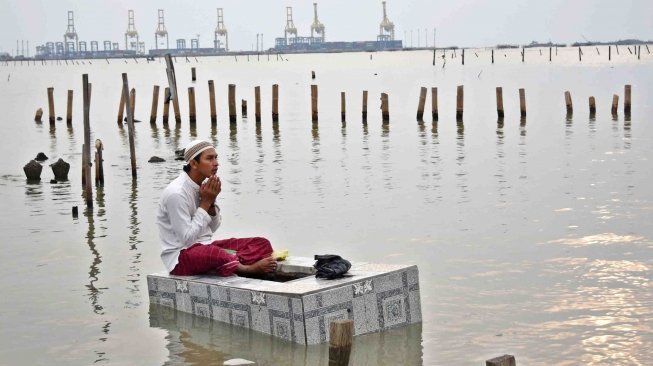 Warga berziarah di makam kerabatnya di tempat pemakaman umum (TPU) yang terdampak abrasi di Tambaklorok, Semarang, Jawa Tengah, Rabu (16/5). 