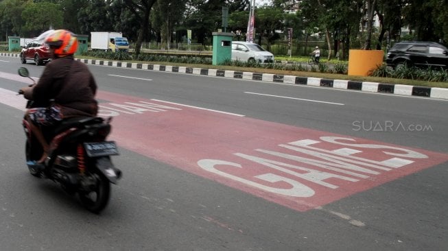 Kendaraan melintas di samping jalur khusus kontingen Asian Games 2018 di Jalan Benyamin Sueb, Kemayoran, Jakarta, Selasa (22/5).