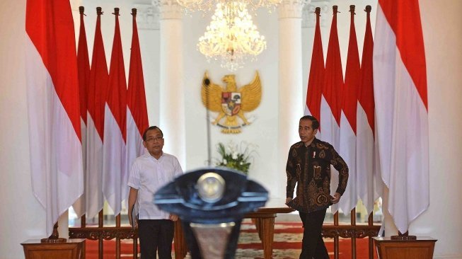 Presiden Joko Widodo (tengah) didampingi Mensesneg Pratikno (kiri) memberikan keterangan pers di Istana Kepresidenan Bogor, Jawa Barat, Selasa (12/6). 