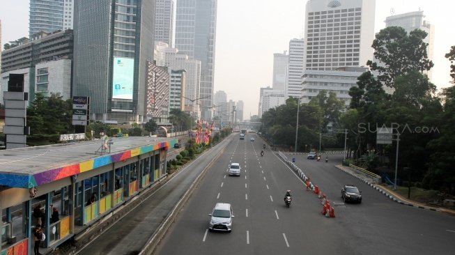 Kendaraan melintas di Jalan Jenderal Sudirman, Jakarta, Rabu (13/6).