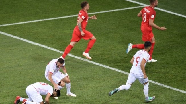 Gelandang Tunisia, Ferjani Sassi (kiri) melakukan sujud syukur usai membobol gawang Inggris via titik putih (NICOLAS ASFOURI / AFP)