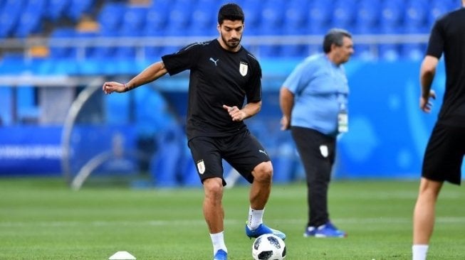 Pemain depan Uruguay Luis Suarez menandang bola saat sesi latihan. Joe KLAMAR / AFP