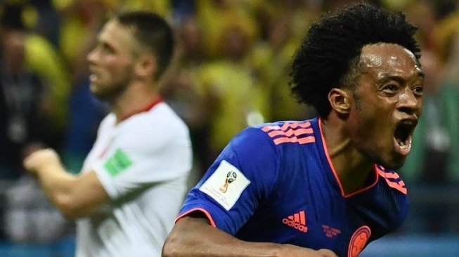 Pemain Kolombia Juan Cuadrado merayakan golnya ke gawang Polandia. Jewel SAMAD / AFP