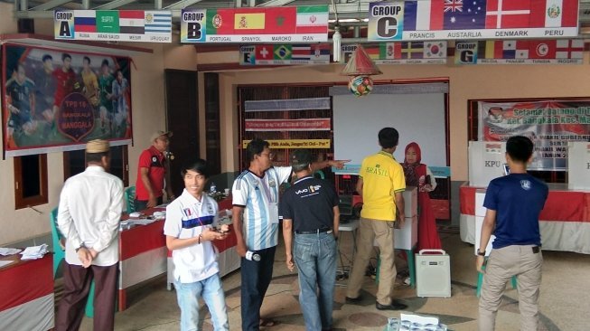 Bendera-bendera kontestan Piala Dunia 2018 menghias lokasi TPS di Kecamatan Manggala [Suara.com/Lirzam Wahid].