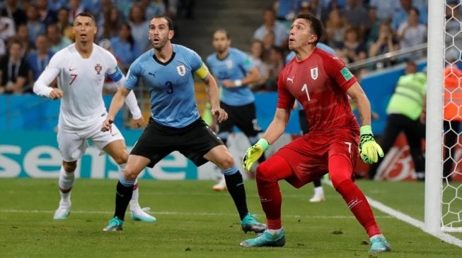 Kapten Timnas Uruguay Diego Godin (tengah) coba menyambut bola di dalam kotak penalti Uruguay, demikian pula kiper Uruguay Fernando Muslera (kanan) dan kapten Portugal Cristiano Ronaldo (kiri) (Anadolu Agency)