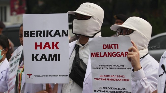 Ratusan orang yang tergabung dalam Pergerakan Dokter Muda Indonesia melakukan aksi di depan Taman Aspirasi Monas, Jakarta, Jumat (19/7). Dalam aksinya mereka meminta agar Kemeristekdi mengeluarkan ijazah Dokter yang disita.[suara.com/Muhaimin A Untung]
