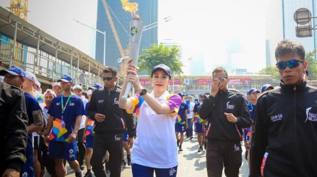 Bank BRI melakukan Kirab Obor/Torch Relay Asian Games XVIII, yang dilaksanakan di Jalan Jenderal Sudirman, Jakarta Pusat, Sabtu (18/8/2018). (Dok: Bank BRI)