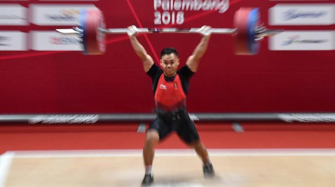 Lifter Indonesia Eko Yuli Irawan melakukan angkatan "snatch" pada nomor angkat besi putra 62 kg Group A, Asian Games ke-18 2018 di JiExpo Jakarta, Selasa (21/8). Eko berhasil meraih emas pada nomor tersebut. ANTARA FOTO/INASGOC/Fanny Octavianus