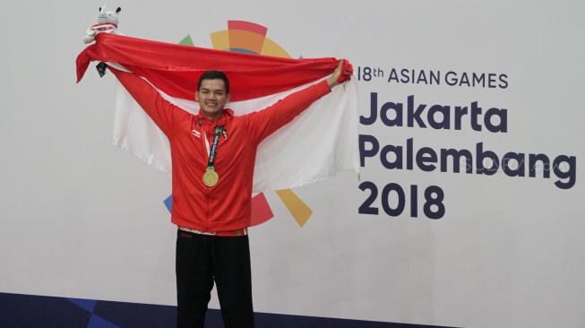 Aji Bangkit Pamungkas mendapatkan medali emas usai mengalahkan pesilat Singapura Sheik Ferdous Sheik Alauddin dalam babak final Kelas I Putra Asian Games 2018.[Suara.com/Oke Dwi Atmaja]