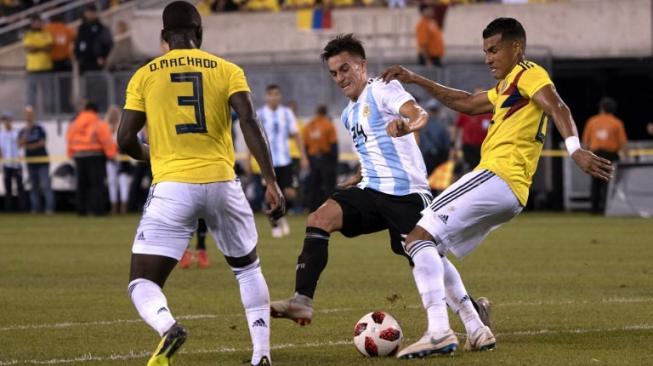 Gelandang Argentina Franco Cervi (tengah) membawa bola ditempel ketat pemain Kolombia Deiver Machado. Don EMMERT / AFP