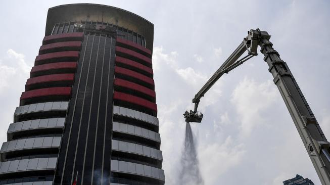 Petugas pemadam kebakaran memadamkan api saat simulasi penanggulangan kebakaran di gedung KPK, Jakarta, Jumat (14/9). [ANTARA FOTO/Sigid Kurniawan]