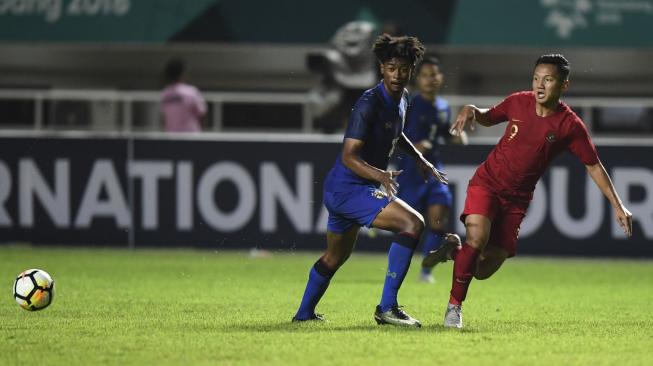 Pesepak bola Timnas U-19 Syahrian Abimanyu (kanan) melewati hadangan pesepak bola Thailand U-19 Saranyu Palangwan (kiri) saat laga PSSI 88th U19 International Tournament di Stadion Pakansari, Cibinong, Bogor, Jawa Barat, Minggu (23/9). ANTARA FOTO/Hafidz Mubarak A