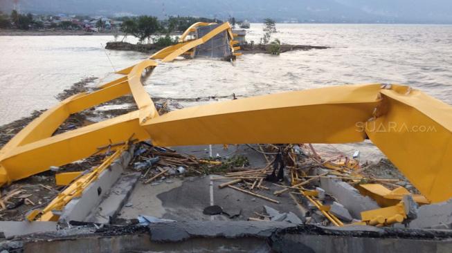Suasana jembatan kuning yang ambruk akibat gempa dan tsunami di Palu, Sulawesi Tengah, Minggu (30/9). (Suara.com/Muhammad Yasir).