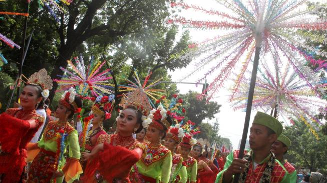 Suasana pawai obor Asian Para Games 2018 ketika melintas di kawasan Jalan Medan Merdeka Selatan, Jakarta, Minggu (30/9). [Suara.com/Oke Dwi Atmaja]