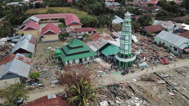 Suasana Masjid Al Amin diantara bangunan yang rusak akibat gempa dan tsunami di Wani, Donggala, Sulawesi Tengah, Minggu (14/10). [ANTARA FOTO/Wahyu Putro] 