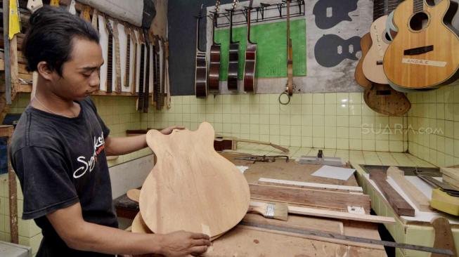 Proses pembuatan gitar di Syukey Guitars, Ciputat, Tangerang Selatan, Selasa (16/10). (Suara.com/Fakhri Hermansyah)