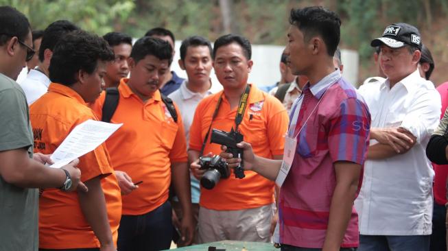 Tersangka mencontohkan menembak saat melakukan gelar rekonstruksi terkait kasus peluru nyasar gedung DPR RI di Lapangan Tembak, Senayan, Jakarta, Jumat (19/10). [Suara.com/Muhaimin A Untung]